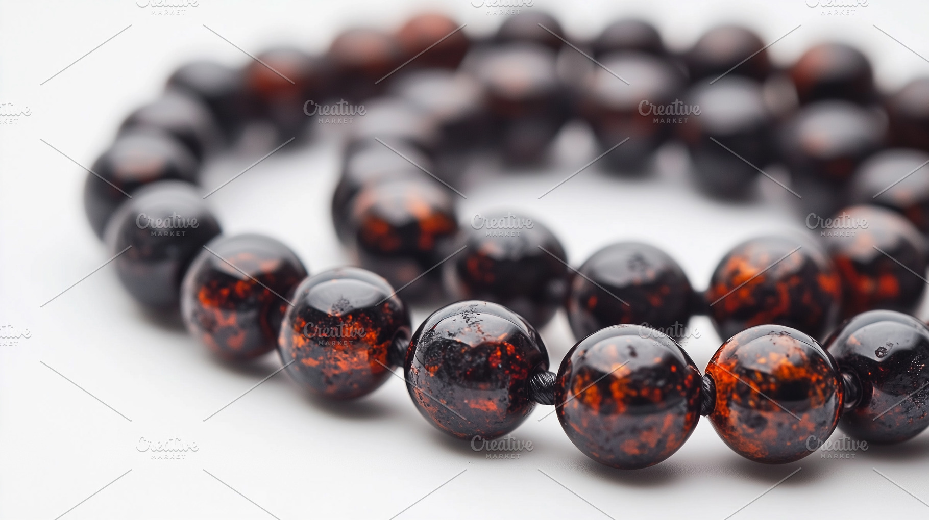 Dark amber stone beads on white, a Background Photo by MistyDay