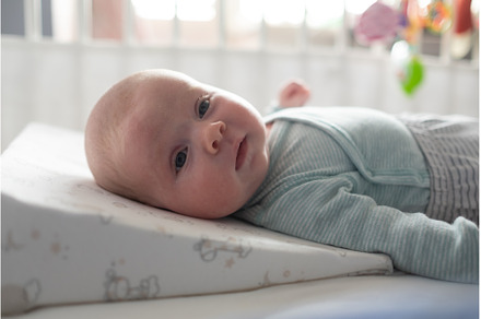 baby lies on a special pillow, a Person Photo by Koldunova