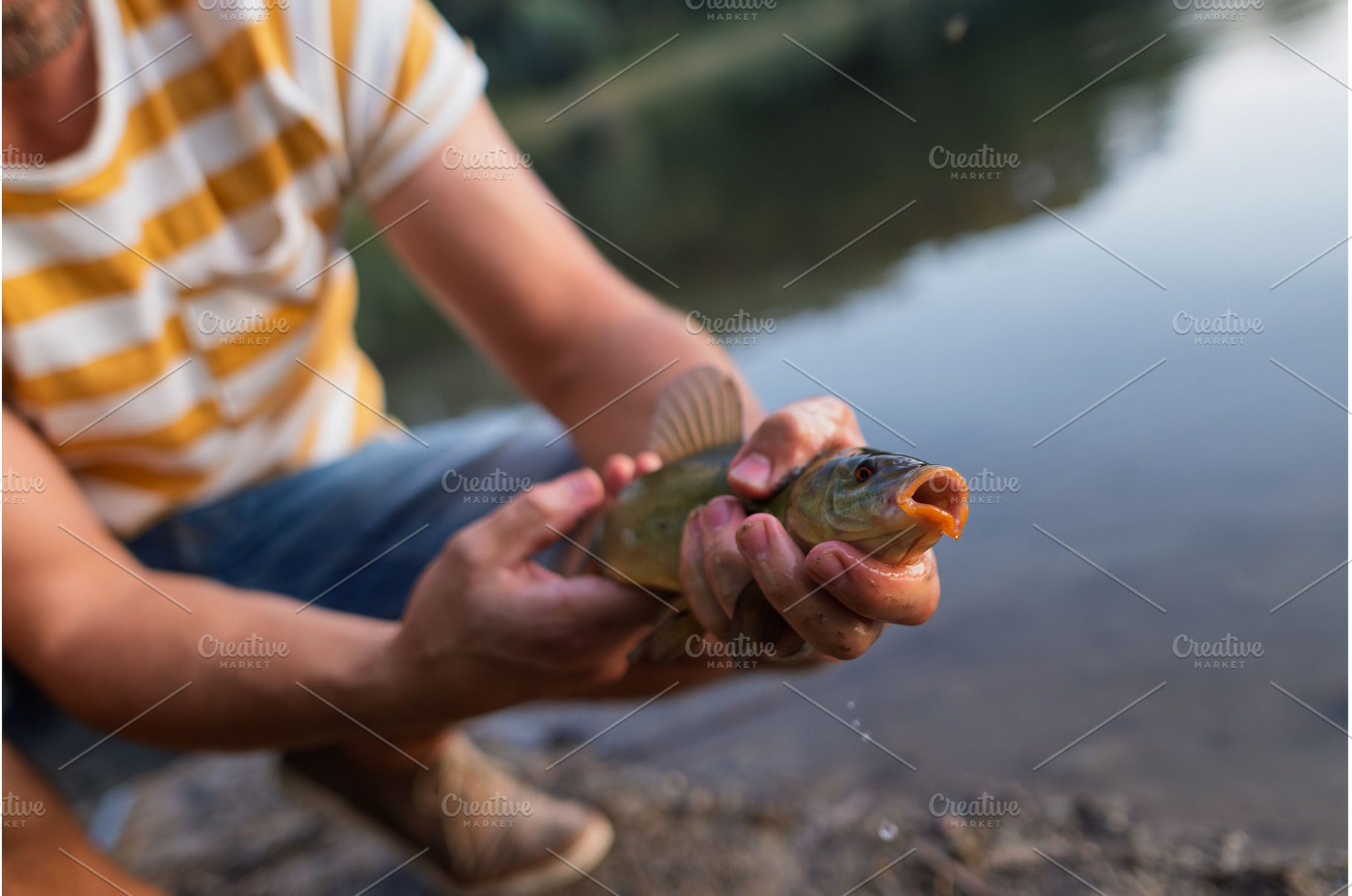 Fisherman holding caught fish during, a Sports & Recreation Photo by HalfPoint