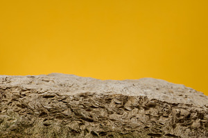 Stones on yellow background, stage for advertising and product d, a Background Photo by ndanko