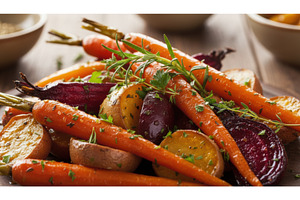 Bundle of bright orange carrots with, a Food & Drink Photo by Igor Tichonow