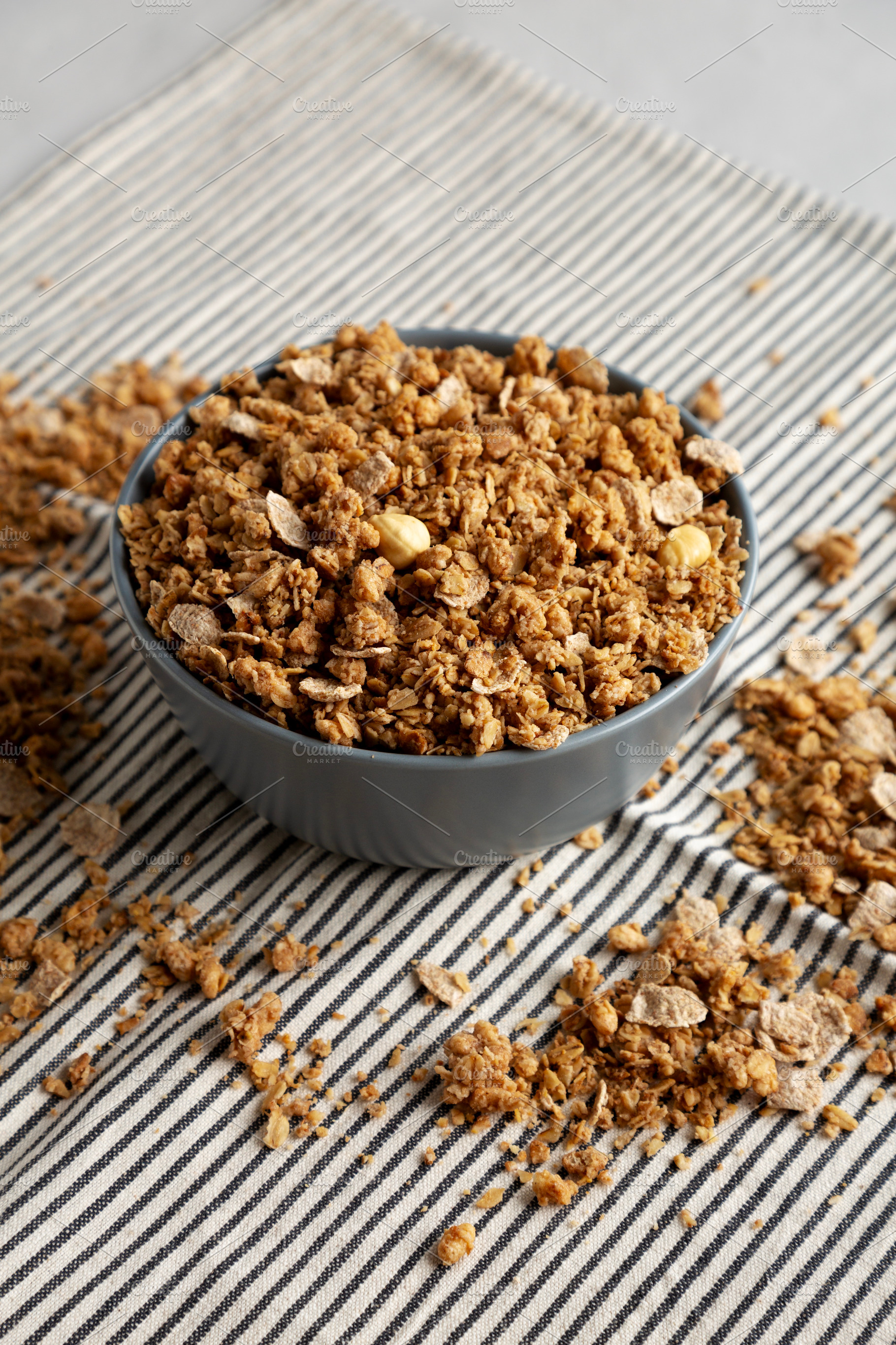 Healthy Homemade Toasted Muesli with Nuts in a Bowl, side view., a Food & Drink Photo by LiudmylaChuhunova