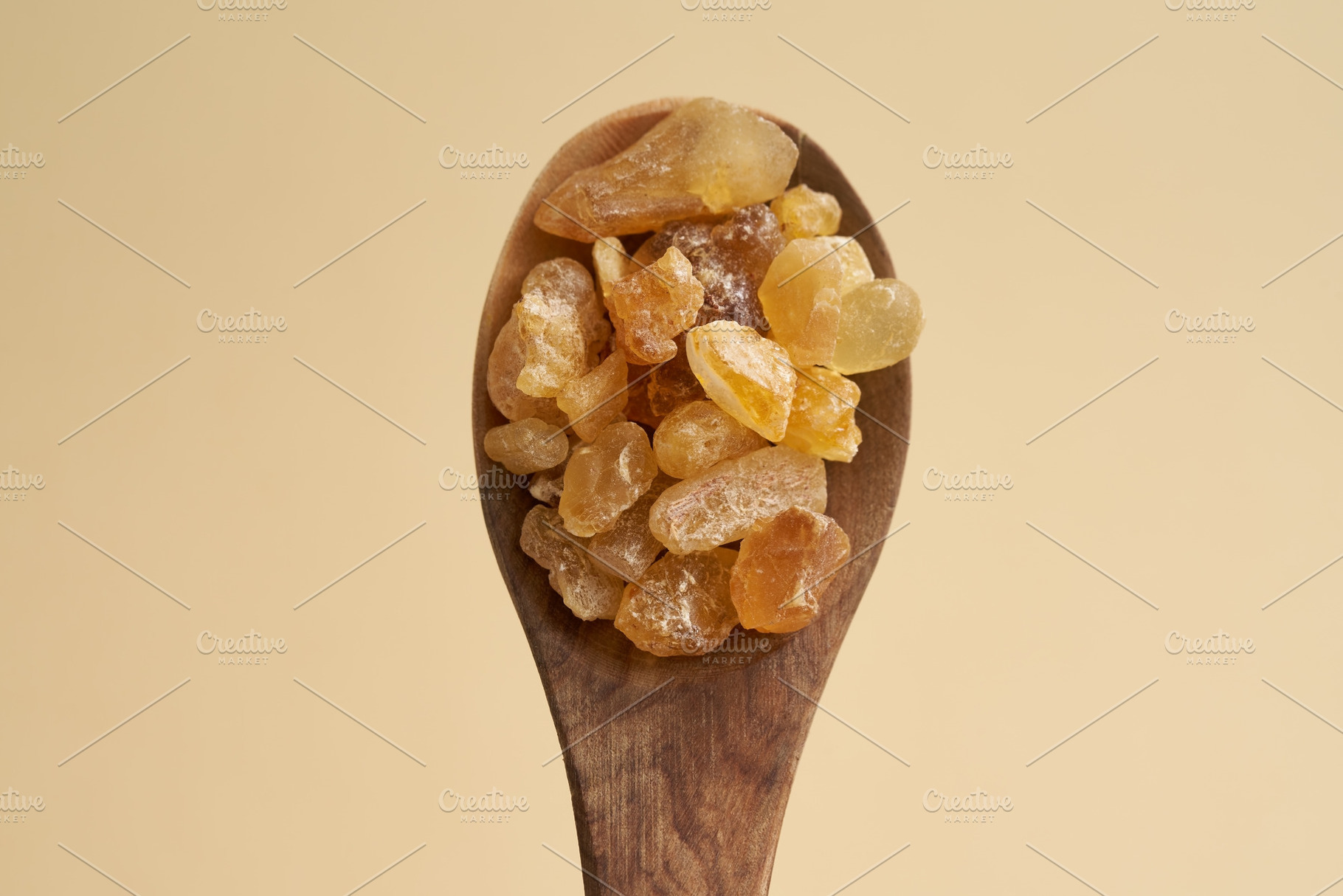 Frankincense resin crystals on a wooden spoon, a Health & Medical Photo by Madeleine Steinbach