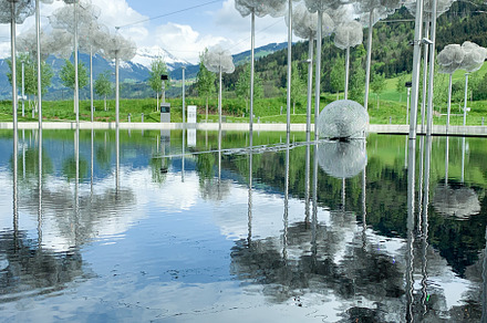 Swarovski museum outdoor installation reflecting on water with s