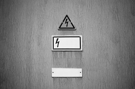 Electricity danger sign on vintage wall backdrop, an Industrial Photo by RETROWAVE '88