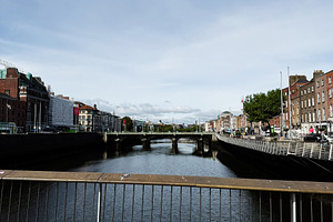 River Liffey bridge view over calm water with Dublin Ireland cit, a Photo by AS photostudio