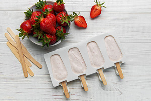 Making strawberry frozen yogurt popsicles for a healthy summer d, a Food & Drink Photo by Olena Rudo