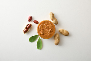 Peanut butter in a bowl and peanuts in the center, a Food & Drink Photo by Davizro's Market