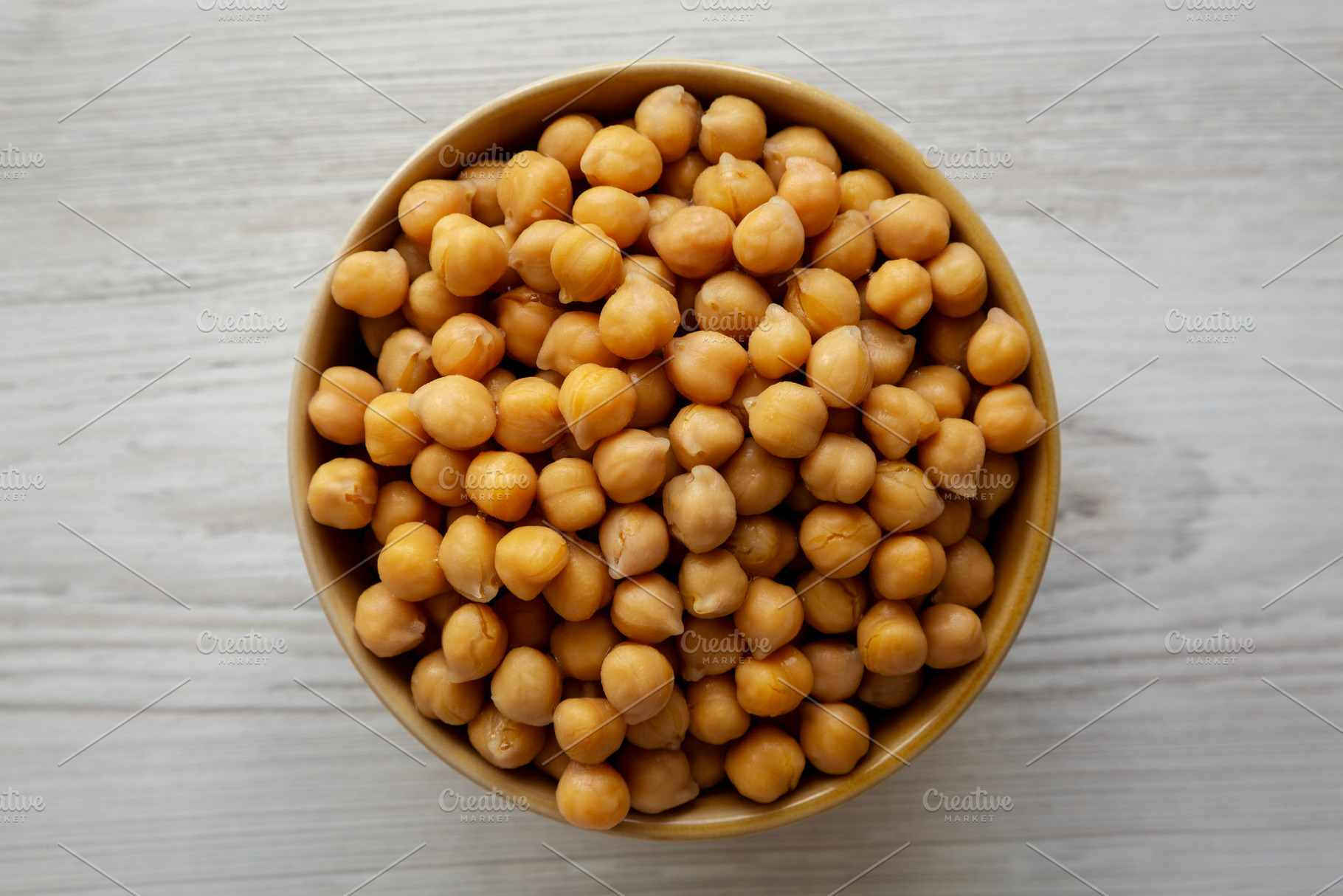 Organic Raw Canned Chickpeas in a Bowl, overhead view. Close-up., a Food & Drink Photo by LiudmylaChuhunova