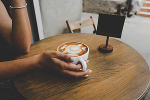 Girl in cafe drinking coffee