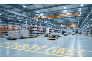 Busy modern warehouse floor features, an Industrial Photo by Igor Tichonow