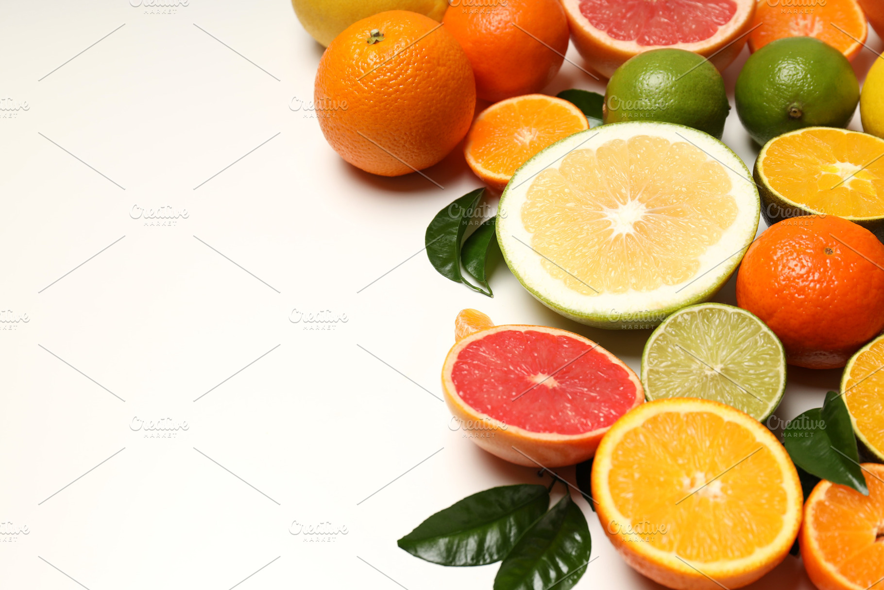 Citrus fruits with leaves on white background, a Food & Drink Photo by AtlasStudio PRO