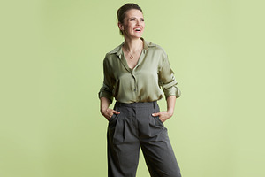 Confident Professional: Woman in Green Silk Blouse, a Business Photo by Alliance Images