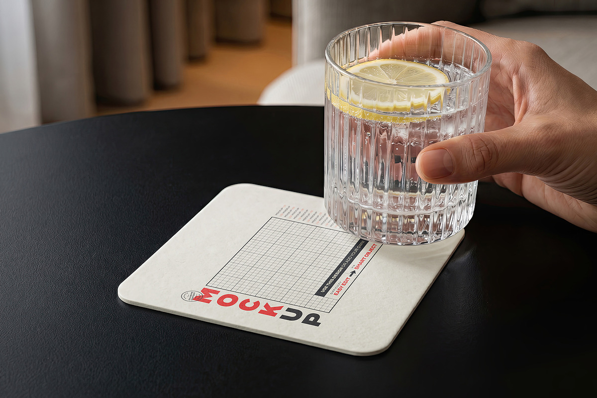 Coaster with Drink and Hand Mockups, a Merchandise Mockup by Luuqas Design (Photo 2 of 3)