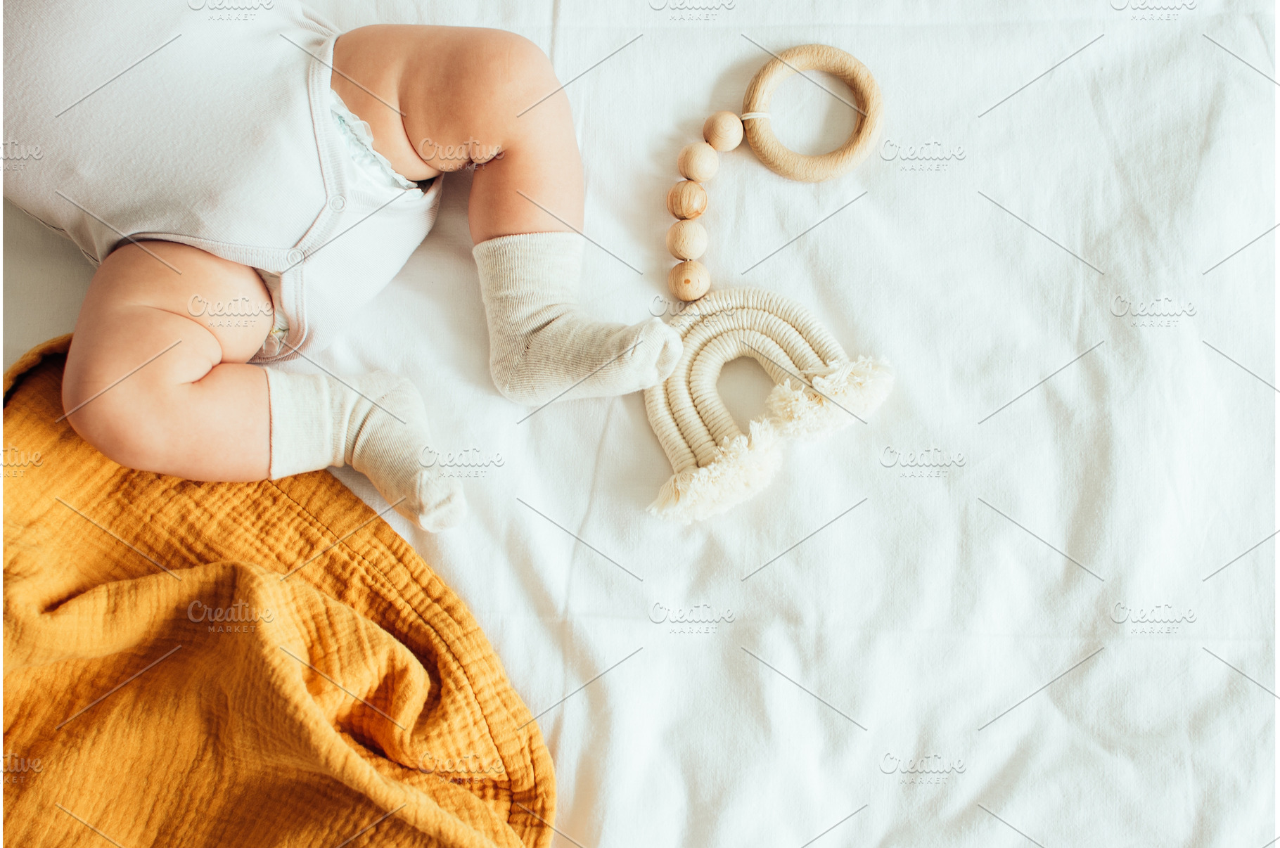 Baby playing with a wooden toy on, a Food & Drink Photo by NelliKovalchuk