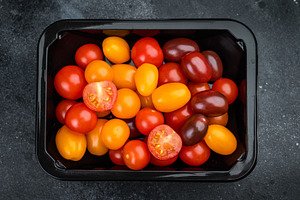 Fresh organic cherry tomatoes arranged in a retail style contain, a Food & Drink Photo by composter-box@mail.ru