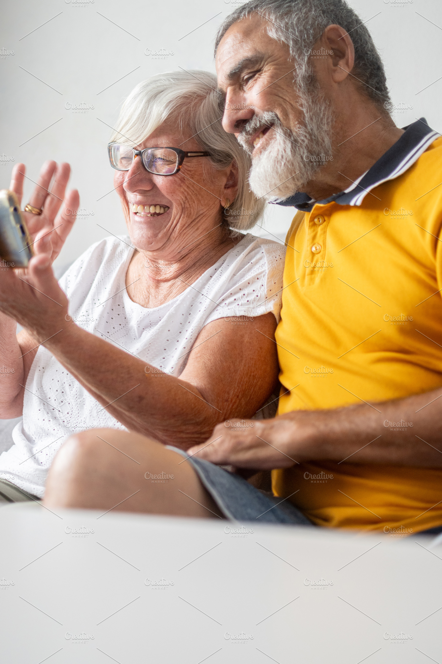 Senior couple enjoying a video call on a smartphone, a Person Photo by etorres69