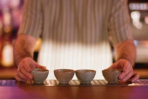 Barman work pub process bartender sake clay bowl, a Food & Drink Photo by Photo Drive Studio