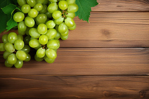 Ripe green grape on wooden background, a Food & Drink Photo by AlyaAnd