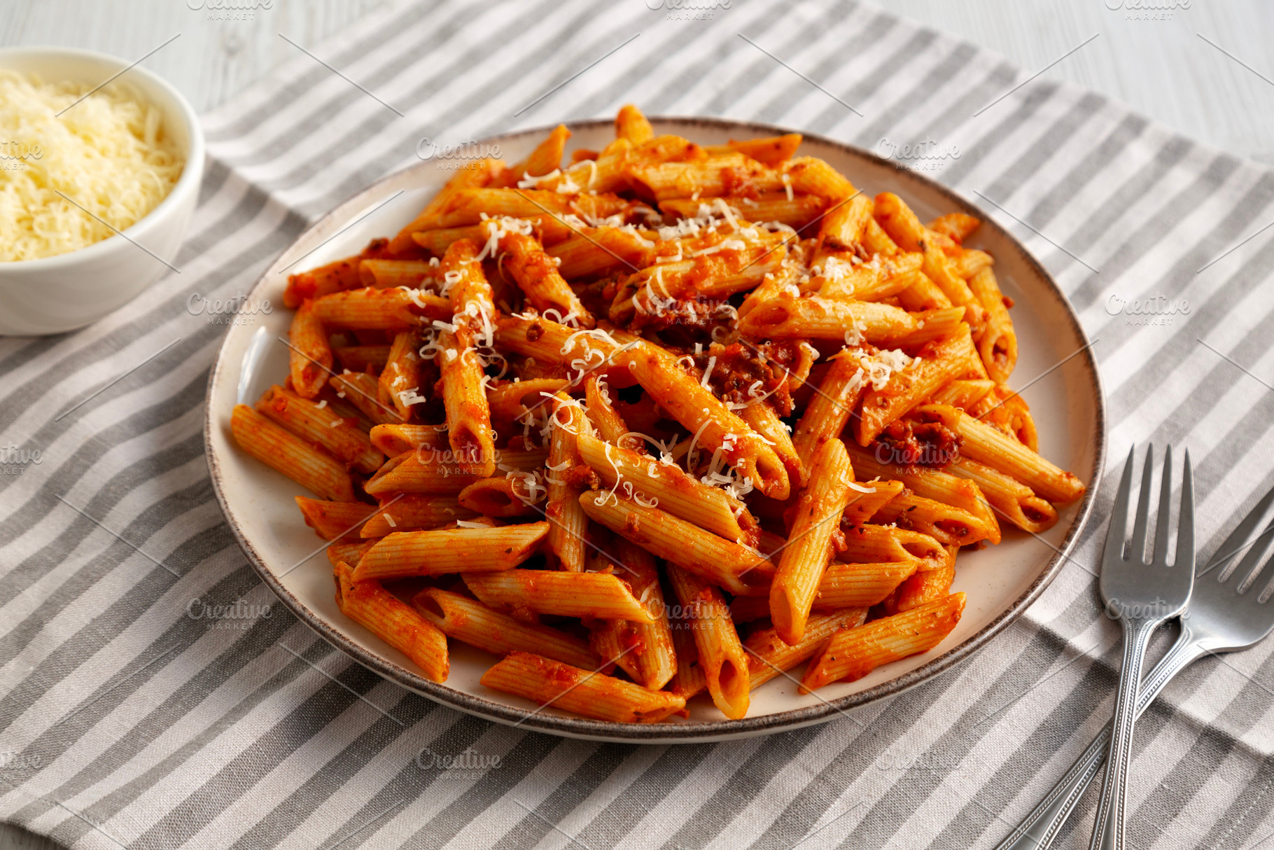 Homemade Pasta Bolognese with Cheese on a Plate, side view., a Food & Drink Photo by LiudmylaChuhunova