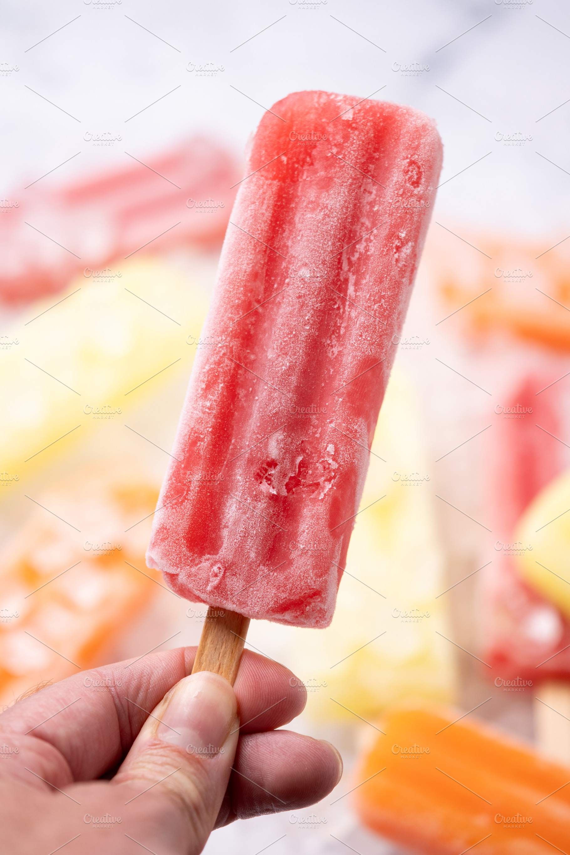 Hand holding red popsicle, a Food & Drink Photo by etorres69