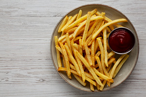 Homemade French Fries and Ketchup on a Plate, top view. Copy spa, a Food & Drink Photo by LiudmylaChuhunova