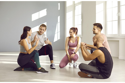 Group of happy young friends sitting, a Sports & Recreation Photo by StudioRomantic
