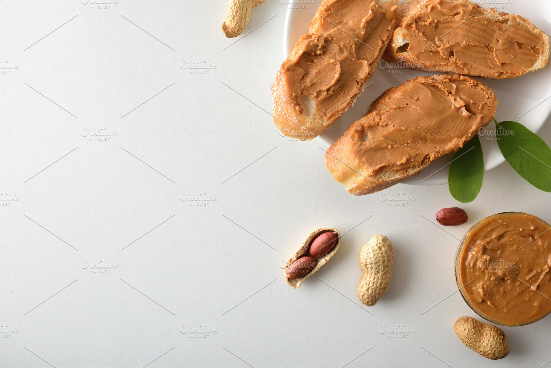 Bread with peanut butter isolated on white table, a Food & Drink Photo by Davizro's Market
