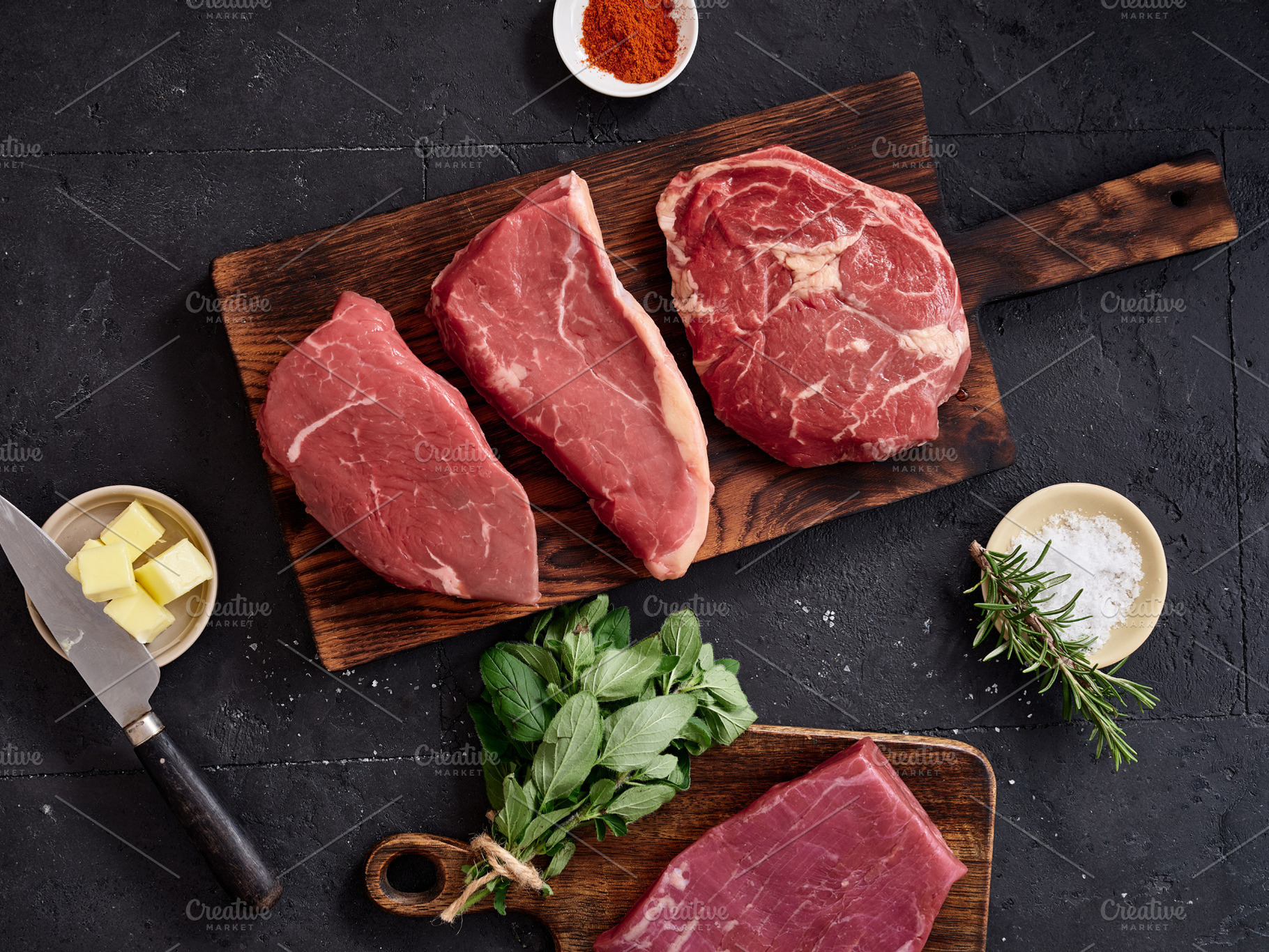 Raw rib-eye, roast beef, flank, and rump steak on a wooden cutting board with s, a Food & Drink Photo by Asya Nurullina