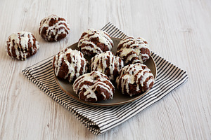 Homemade Profiteroles with Coconut Cream on a Plate, side view., a Food & Drink Photo by LiudmylaChuhunova