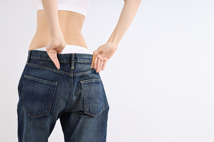 Concept of weight loss, young woman on light background, a Person Photo by AtlasStudio PRO