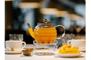 Mango herbal tea in teapot with, a Food & Drink Photo by Fascinadora