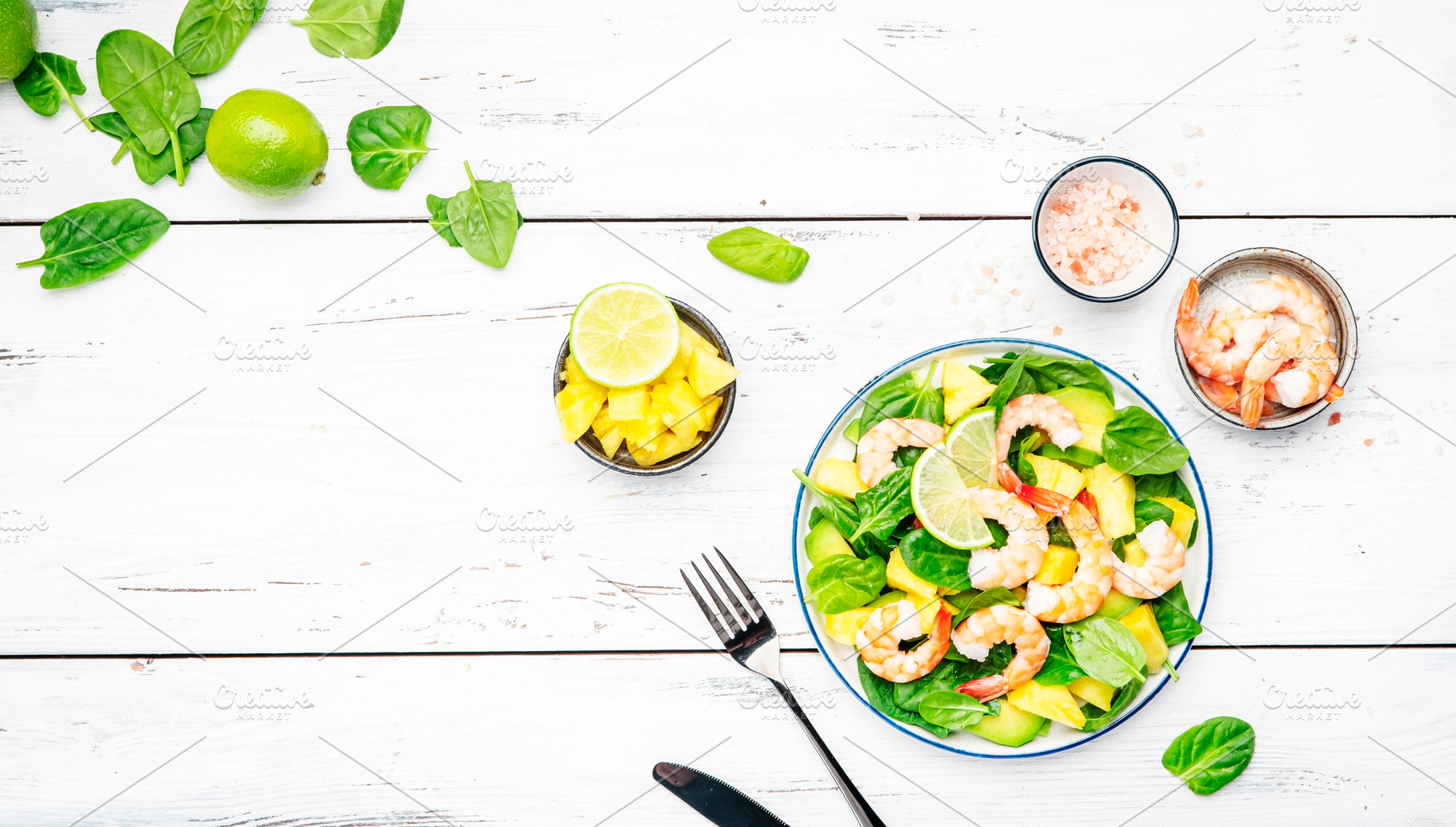 Fresh pineapple salad with shrimps, spinach, avocado and lime on, a Food & Drink Photo by 5PH