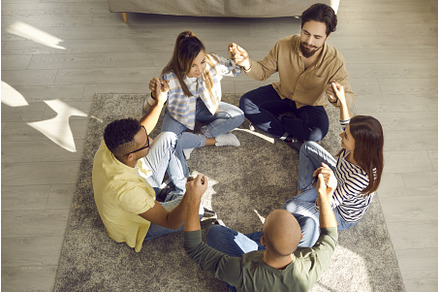 Diverse group of friends sitting in, a Person Photo by StudioRomantic
