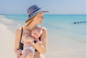 Mother holding her newborn baby by, a Person Photo by Elizaveta Galitskaya