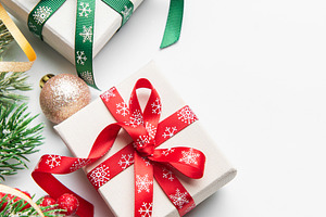 Christmas gifts decorations with holly and ornaments on white, a Holiday Photo by Olena Rudo