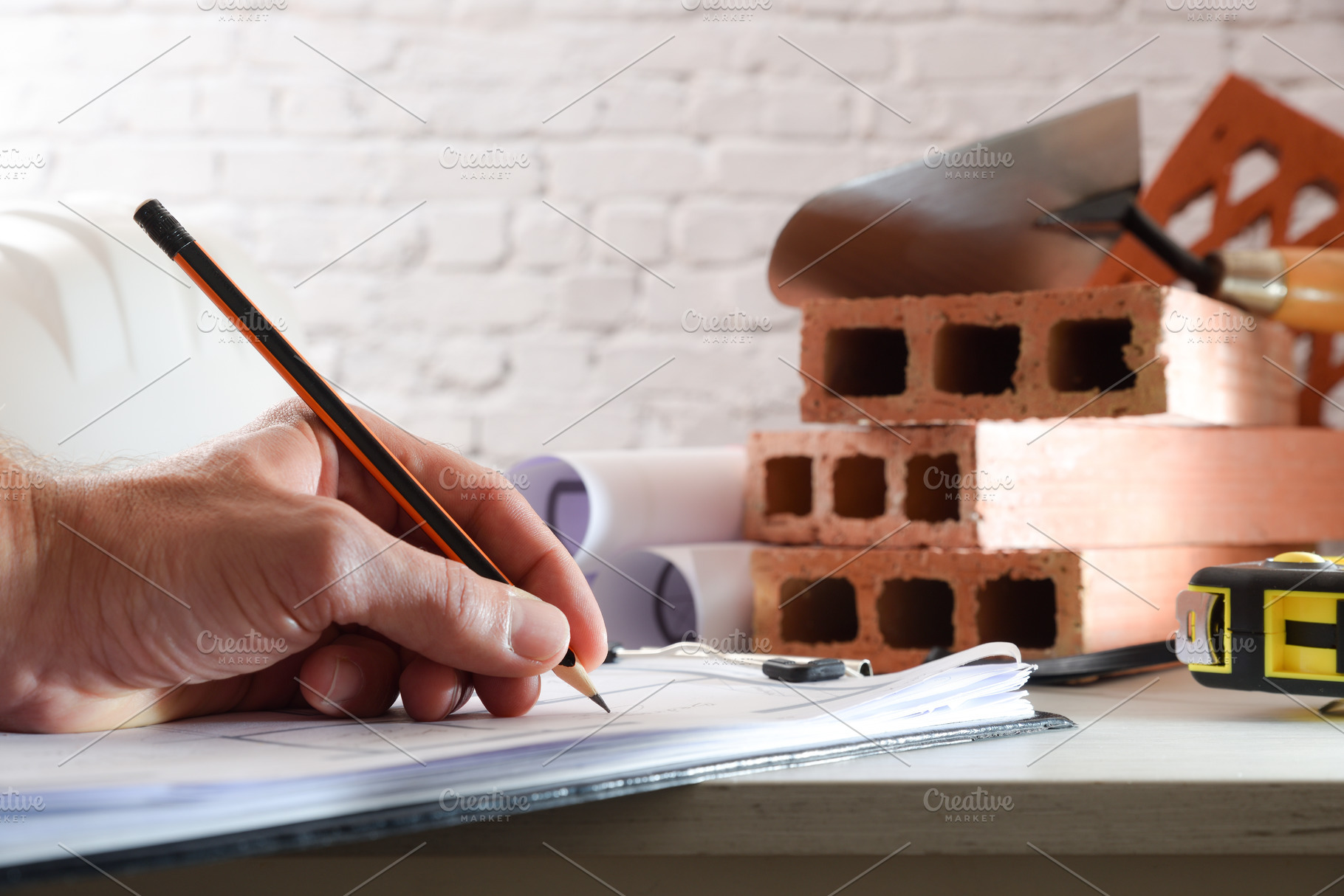 Architect taking notes in office with construction material, an Architecture Photo by Davizro's Market