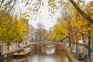 Historic arch bridge over autumn canal in Amsterdam, vertical tr, a Photo by Pictures for you!!!!!!!!!