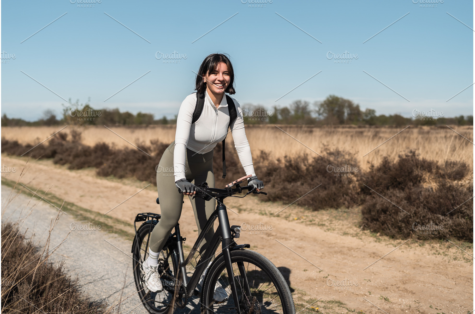Golden hour ride with a smiling, a Sports & Recreation Photo by AD Stock Images