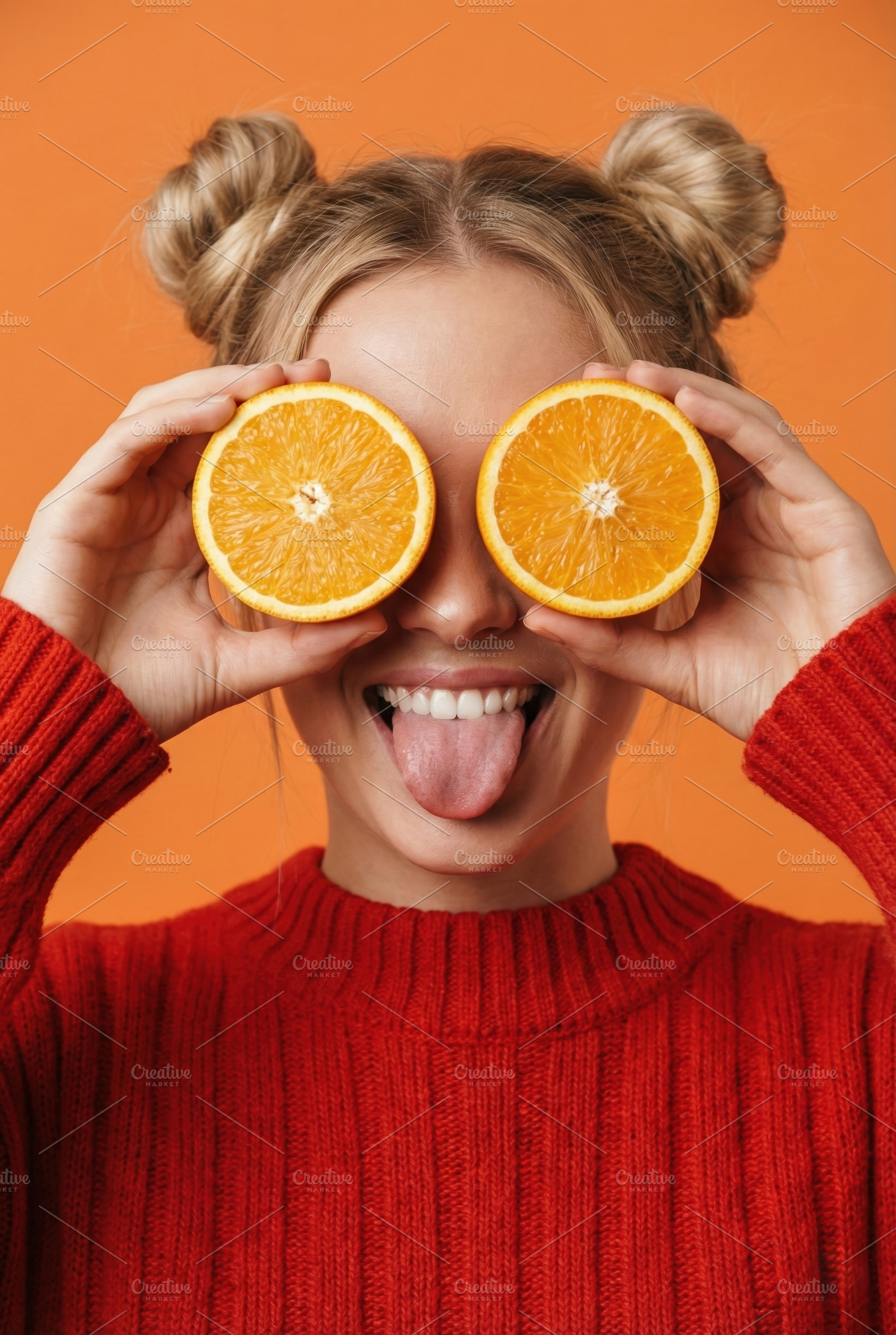 Playful Young Woman Holding Orange, a Person Photo by Virgo Studio