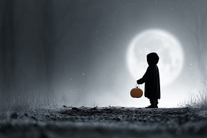 Child in a dark cloak holding bucket, a Holiday Photo by MistyDay