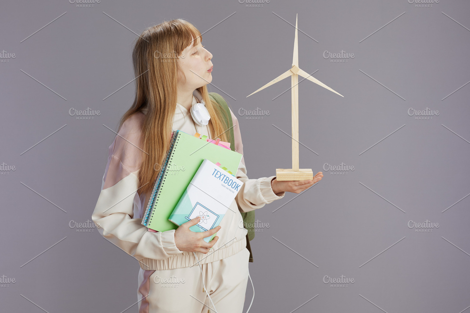 trendy teenage girl in beige tracksuit with workbooks, a School & Education Photo by Alliance Images