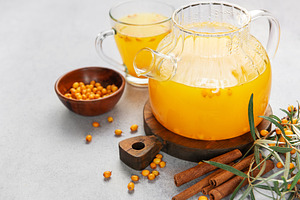 Sea buckthorn tea with cinnamon in a glass teapot, a Food & Drink Photo by Olena Rudo