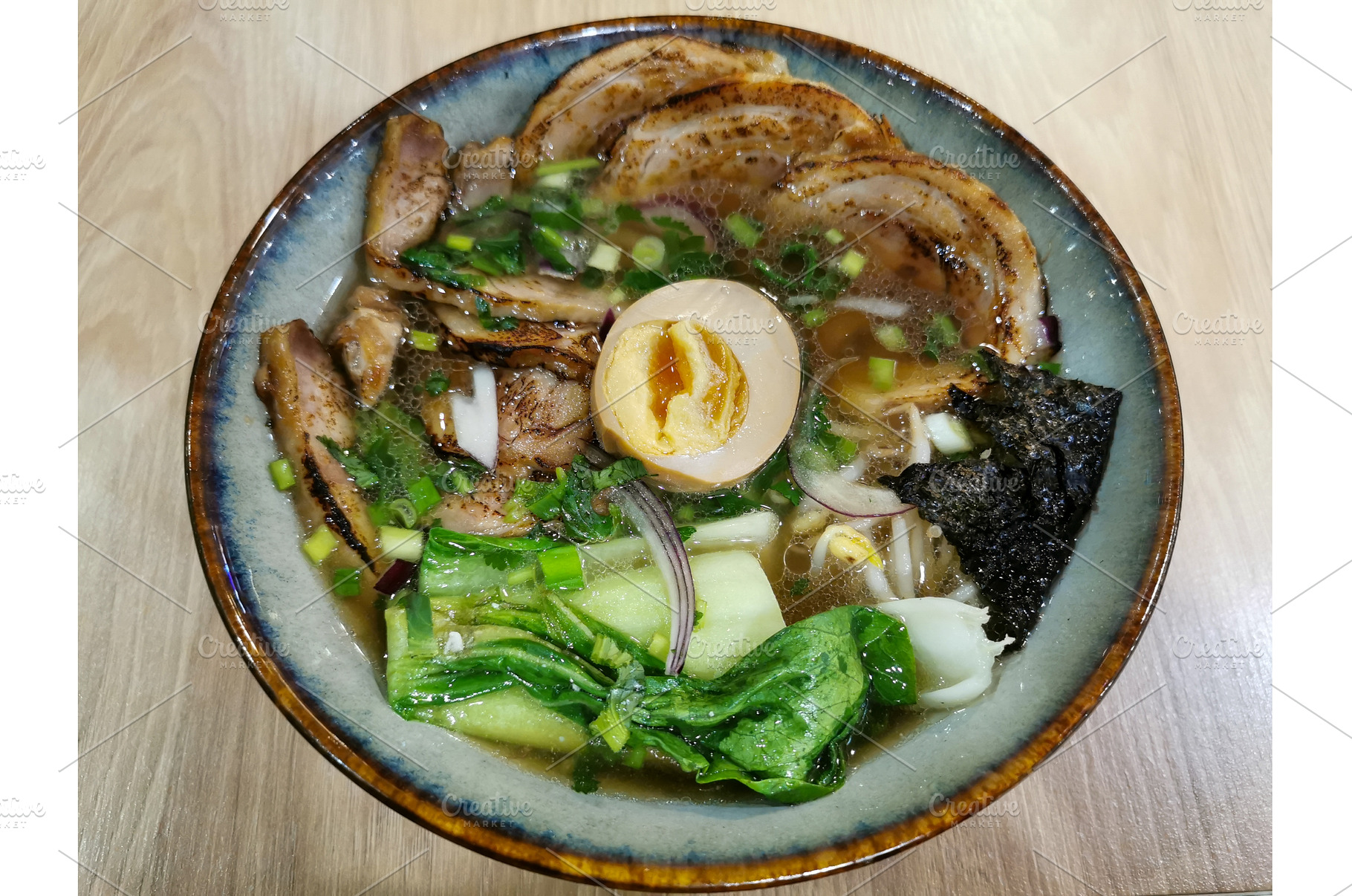 Ramen in ceramic bowl on wooden, a Food & Drink Photo by sceptical cactus