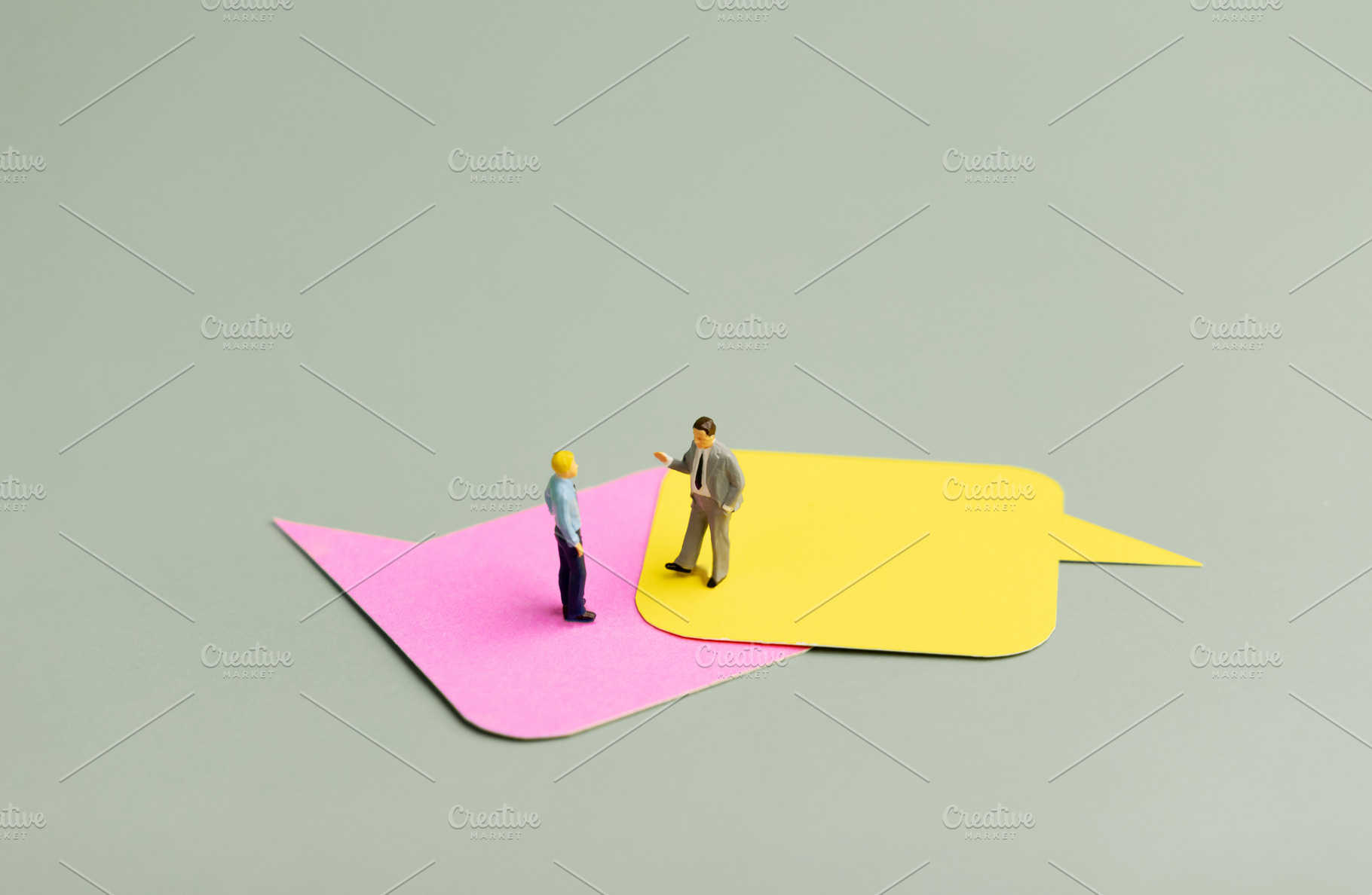 Miniature businessmen on ]speech bubbles,business discussion, co, a Photo by salmon.black