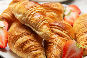 Freshly baked croissants served with juicy strawberries on white, a Food & Drink Photo by Olena Rudo