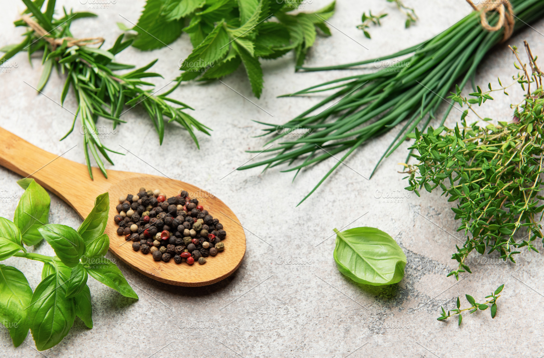 Fresh herbs and peppercorns resting on kitchen table, a Food & Drink Photo by Olena Rudo