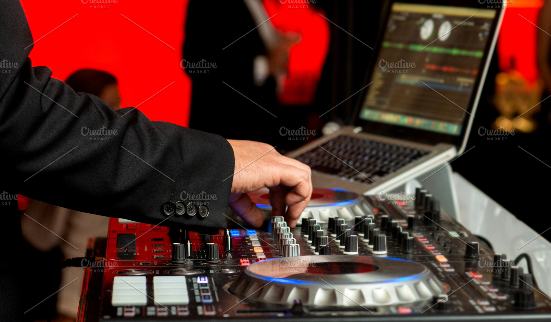 Disc jockey in elegant suit mixes mu, a Holiday Photo by Claudio Valdés
