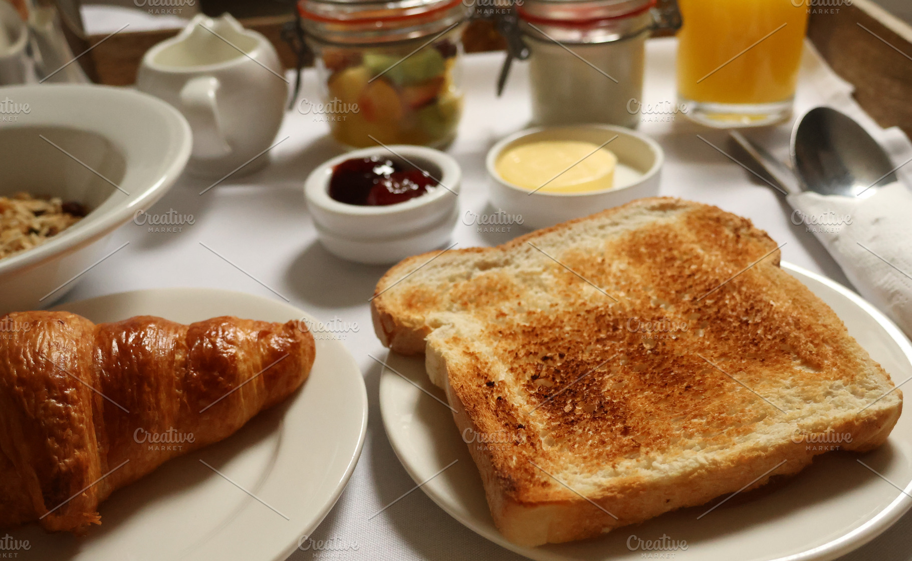 Serving a fresh continental breakfast spread with various delicacies on a white, a Photo by Studio ANNA