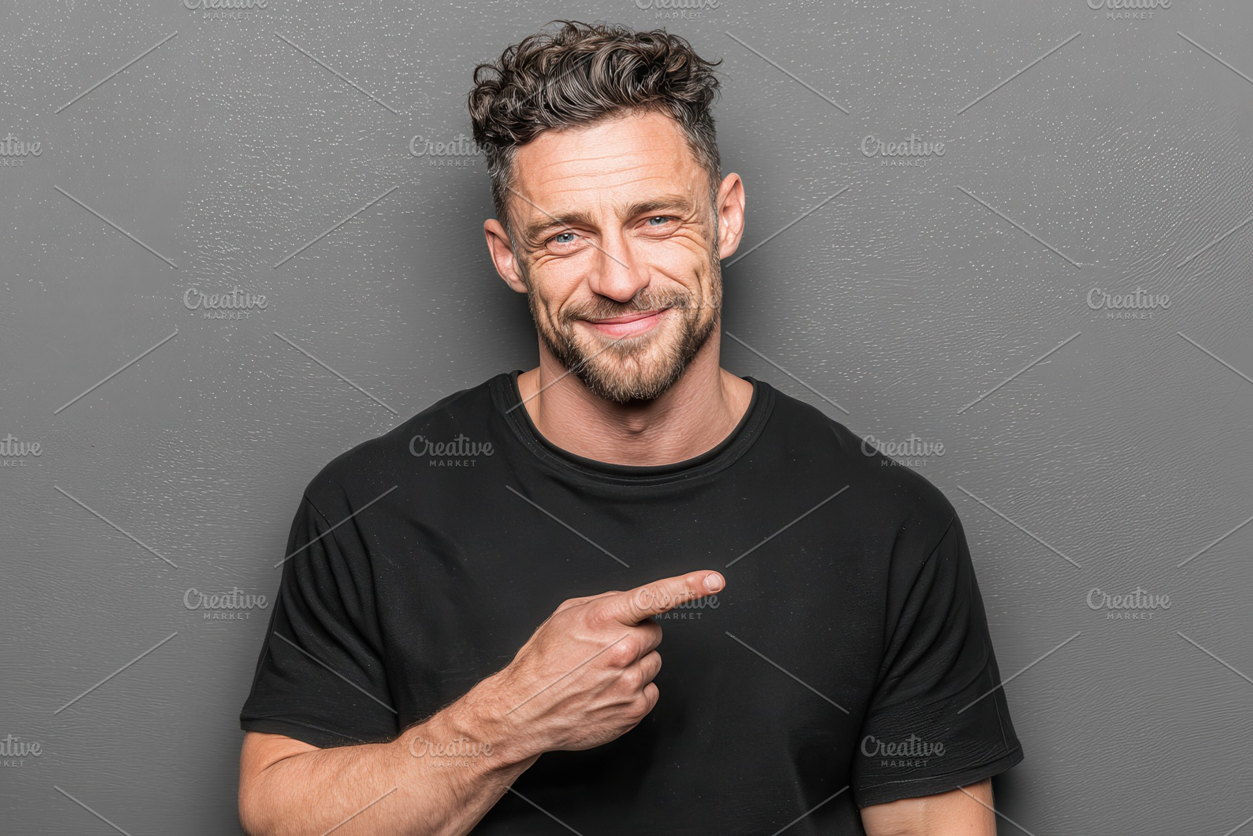 Man in black shirt points playfully, a Photo by Pixeness Studio